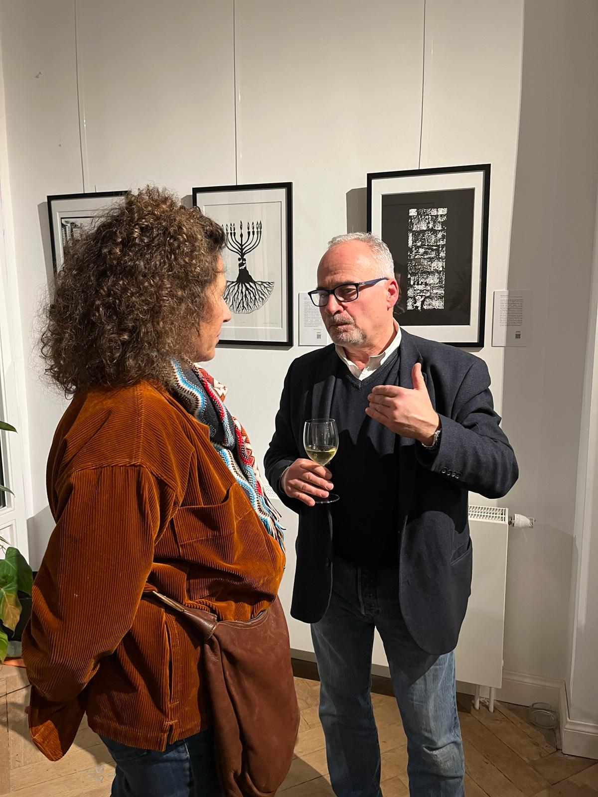 Visitors talking in front of works at Full Circle